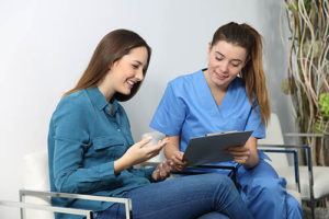 a woman talking to a nurse about anesthesia for gynecology and fertility